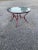 Beautiful geometric pattern on this Woodard style patio table with glass table top.