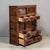 Antique Japanese merchant chest (Choba Tansu) featuring nine drawers and a pair of small sliding doors, accented with hand...