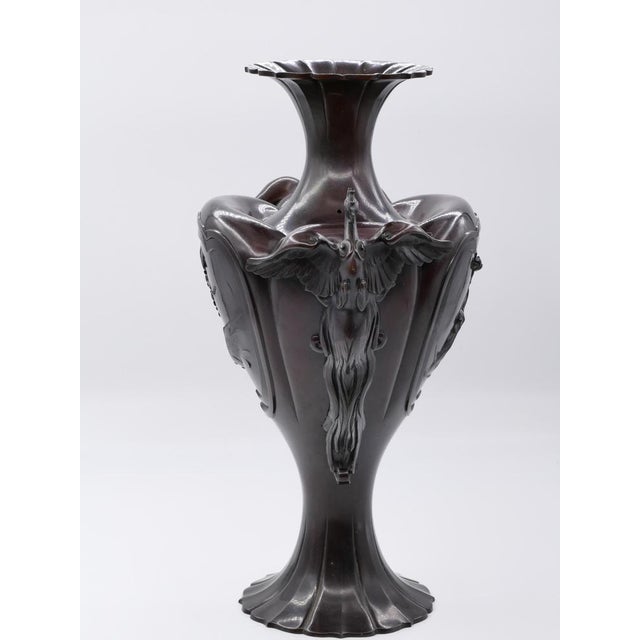 This Meji bronze amphora is a superb bronze vase decorated with the depiction of flowers and frogs and on the sides a...