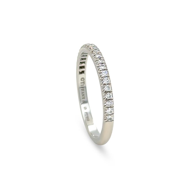 An elegant Tiffany & Co. Soleste half eternity ring crafted in platinum, showcasing a row of brilliant diamonds totalling...