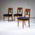 Set of three Biedermeier chairs crafted from walnut. The backrests feature ebonized pierced decoration in the form of...