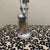 This charming vintage figurine depicts an elegant woman in a mid-century take on Victorian fashion. She is dressed in a...