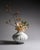 Large Plissé vase in matte white porcelain with deep flowing pleats that catch light with quiet precision. The folded...