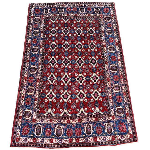 A beautiful antique Veramin rug, woven circa 1920. The rug features an allover Mina Khani design on a terracotta field...