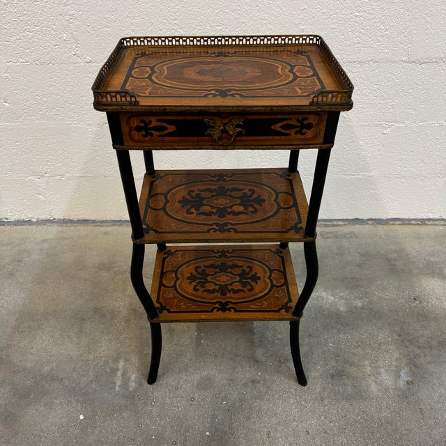 A superb French side table in the Napoleon III style, crafted with remarkable marquetry of floral and geometric veneer....