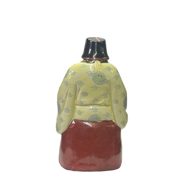 This vintage Chinese Feng Shui porcelain figure features a deity clad in a resplendent yellow dress, holding a gleaming...