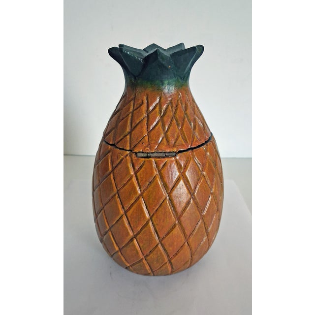 Artisan carved solid wood pineapple trinket box with hinged lid and faux lock. Overall size with lid closed is 7" H x...