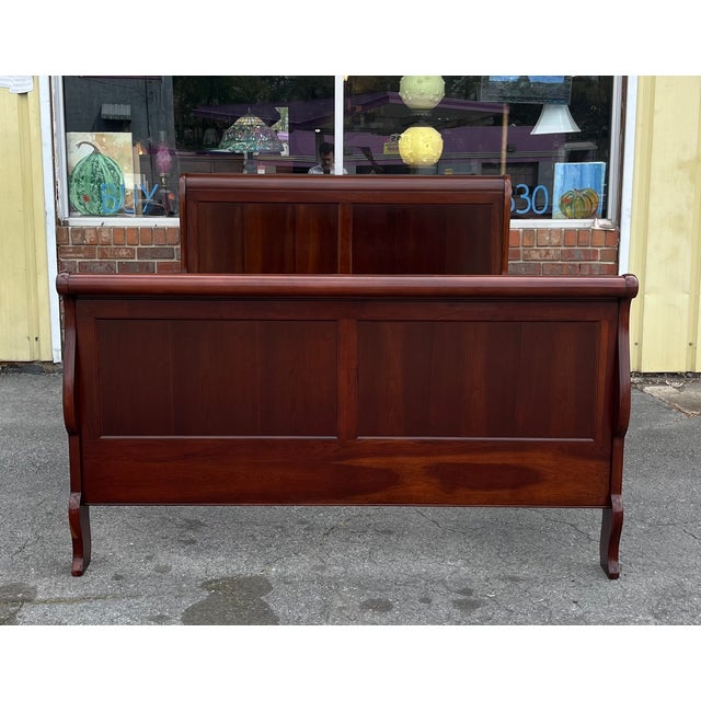 Queen-size sleigh bed by Pennsylvania House. Crafted from high-quality solid cherry, this piece features the classic Louis...