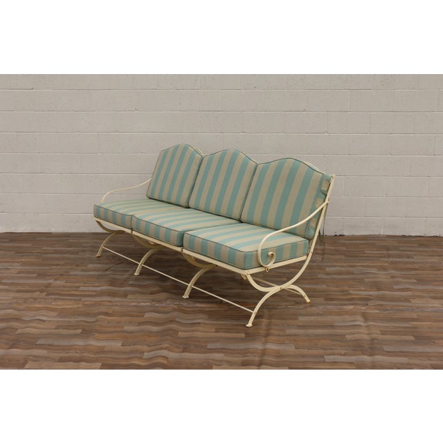 Beautiful vintage French wrought iron three-seat garden sofa attributed to Hervé Baume, circa 1970s. Featuring an elegant...