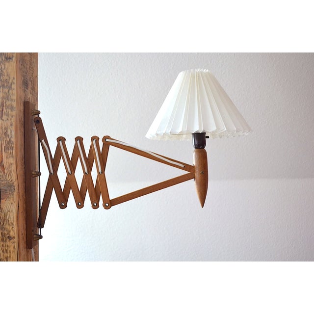 Large mid-century wall lamp by Danish designer Kaare Klint for Le Klint. This wall lamp is a large version, measuring 39cm...