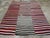 This Mid-20th century Persian Flatweave Kilim rug, displays a bold and lively striped design that captures the energy and...
