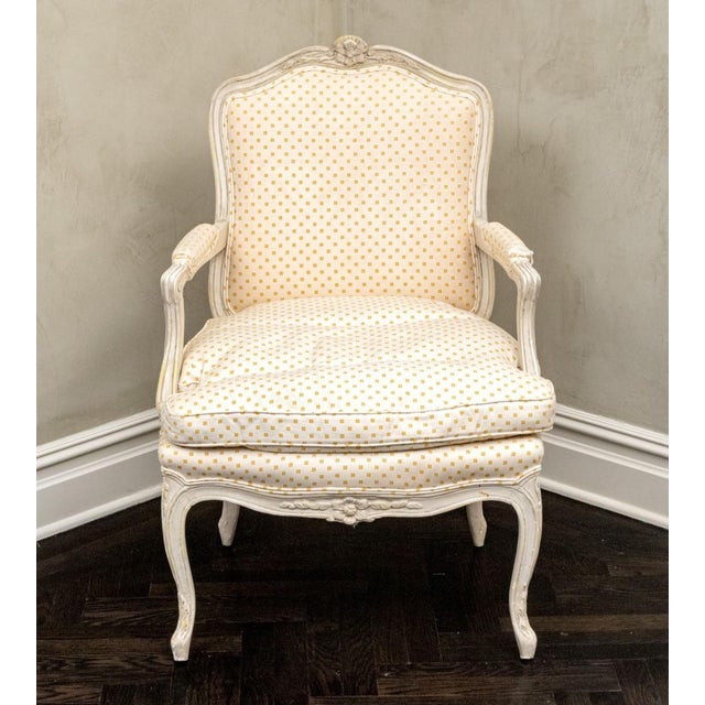Pair of custom Louis XV style carved open armchairs having hardwood frames finished in a white satin paint with yellow...