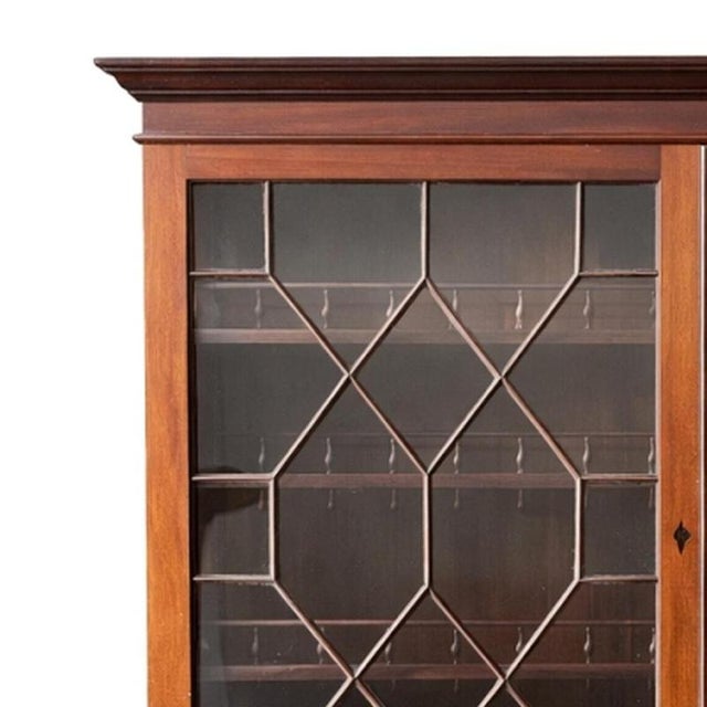 Furniture - China cabinet. Portuguese; 20th century, made of mahogany wood. Upper part with two glazed doors; with shelves...