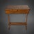 A Biedermeier-era sewing table made of solid cherry wood. The rectangular cabinet rests on two curved sides, which stand...
