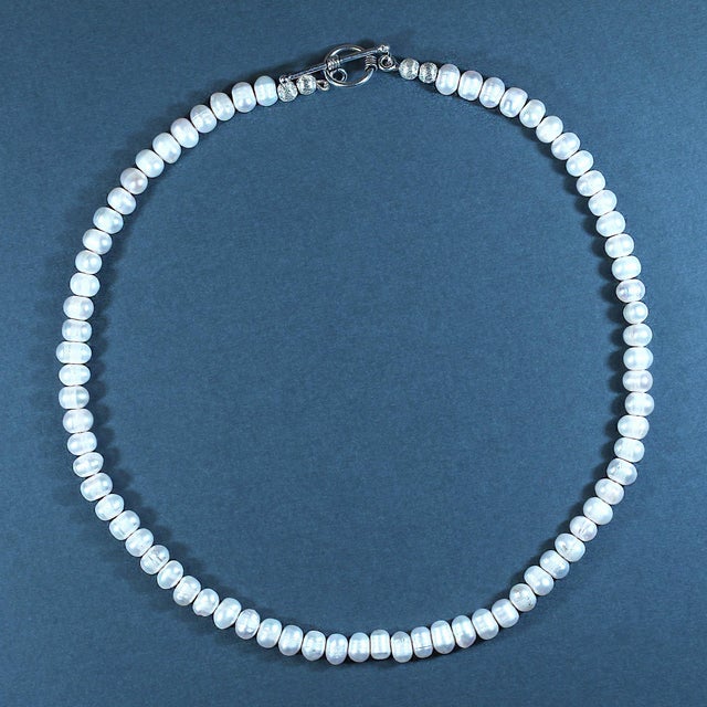 Add timeless elegance to your jewelry collection with this beautiful 18-inch pinkish potato pearl necklace. Featuring...