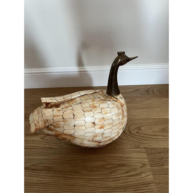 Duck storage. Brass head.the wooden torso is covered with a material unknown to me. It has a few shortcomings. Condition...