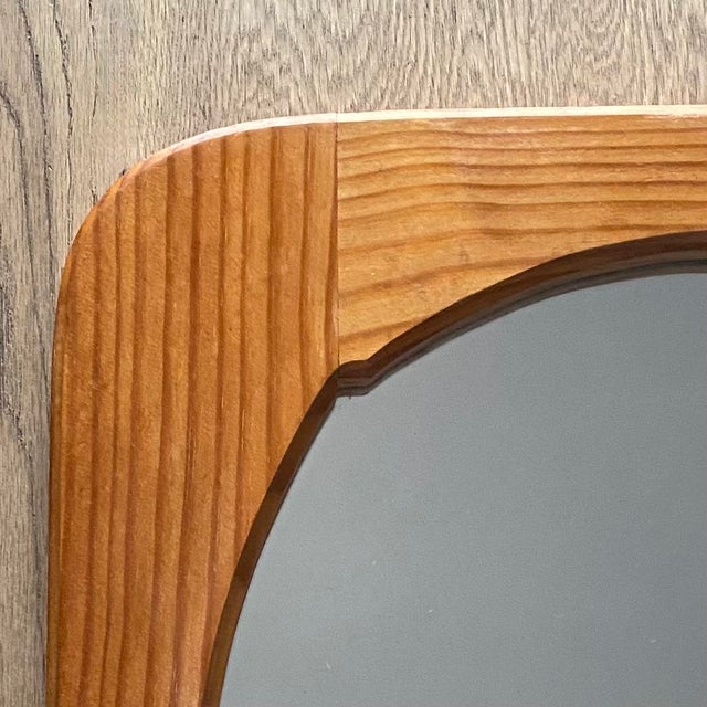 Vintage 1970s solid pine mirror. Its thick frame highlights the wood grain. The structure is composed of four assembled...