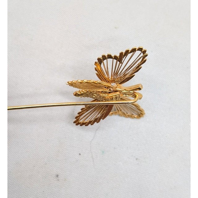 Goldtone wired butterfly jabot pin with clutch clasp. Marked "©MONET" on the back. Measures: 2 1/8 inches long by 1 inch...