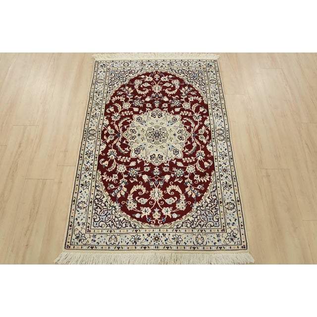 An authentic vintage traditional Nain rug, hand-knotted with fine wool and silk, dyed using natural colors. This...