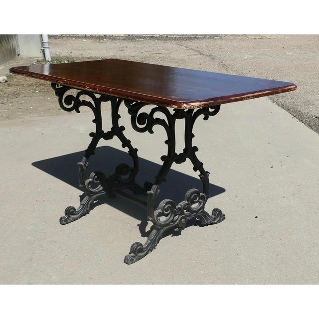 Strong Attractive Cast Iron and Oak Garden Table This lovely table stands on an elaborate iron base, the top of the table...