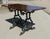 Strong Attractive Cast Iron and Oak Garden Table This lovely table stands on an elaborate iron base, the top of the table...