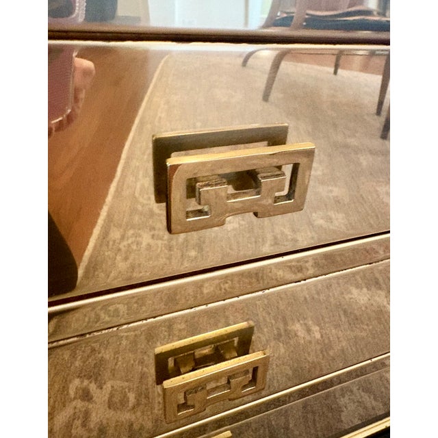 Glamorous solid brass three-drawer campaign chest on a black lacquer pedestal base. Crafted with solid brass panels (not...