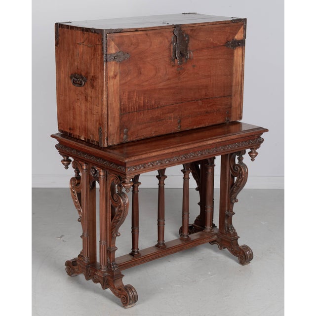 An early 19th century Spanish vargueno, or portable desk, made of hand-planed solid walnut. The drop front opens to an...