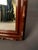 Add warmth and character to any space with this mid-20th century wall mirror, circa 1950. Finished in a rich mahogany-...