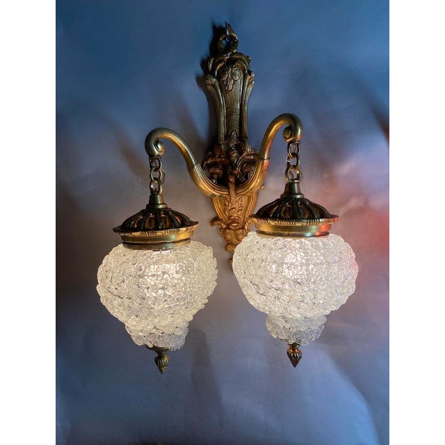 A beautiful pair of vintage French Louis XVI style wall sconces dating from the 1980s, crafted from gilded bronze with...