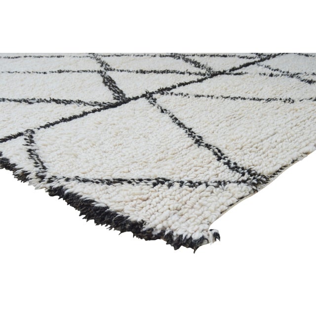 One-of-a-kind hand-knotted Moroccan rug in soft, organic wool with an ornate abstract rhythmic pattern of Berber lozenge...