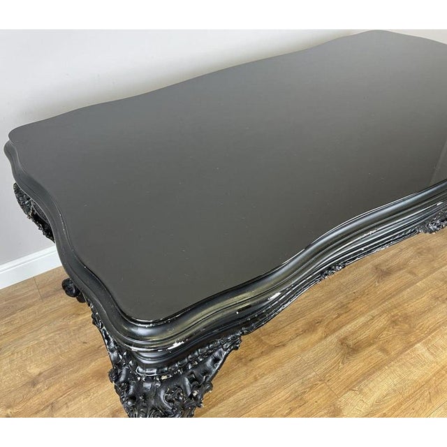 This impressive Antique French double sided desk features a striking black painted finish, elegant shaped top, and highly...