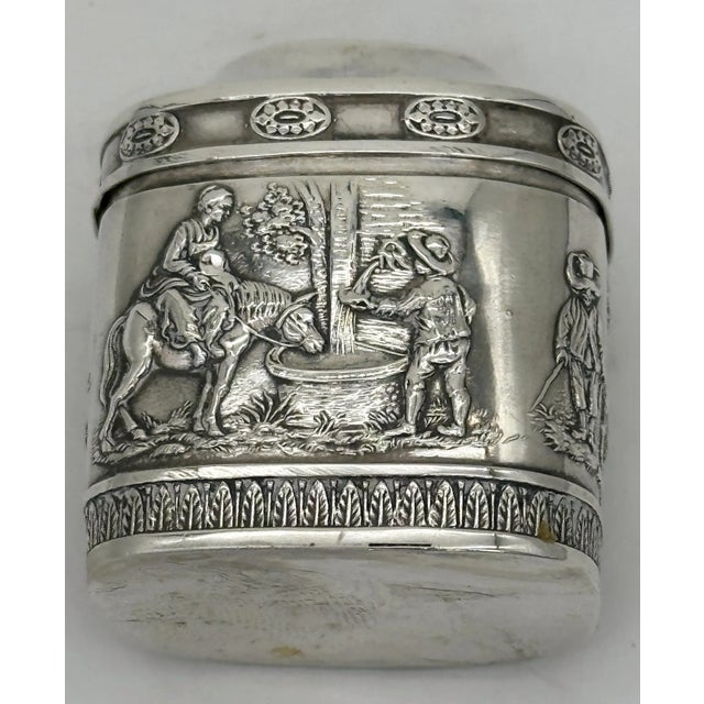 Unusual 19th-century German . 800 Silver Snuff Box with Repoussé Rural Scenes and Fruit Basket Lid A charming and...