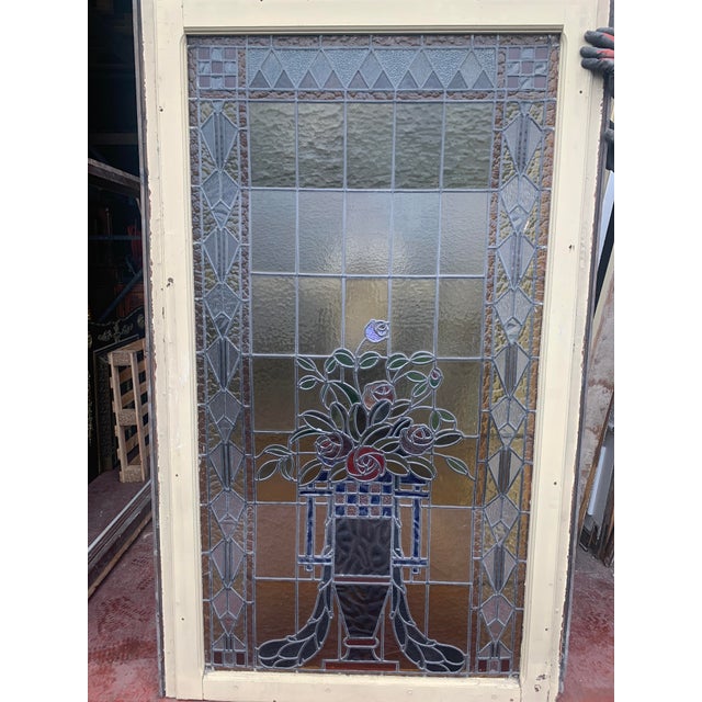 Art deco stained glass window in its wooden frame central scene depicting a medici vase with a bouquet of flowers the...