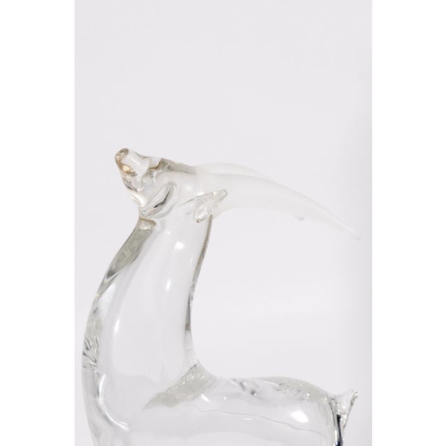 Elegant and refined, this Mid Century Modern signed clear art glass antelope sculpture captures the grace and poise of the...