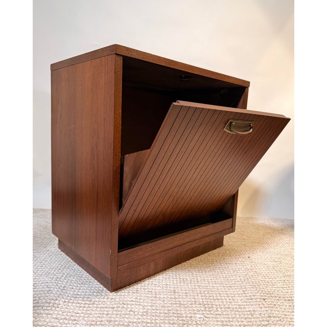 Designed by Lane Furniture and manufactured in 1963, this mid-century walnut drop-front cabinet offers streamlined storage...