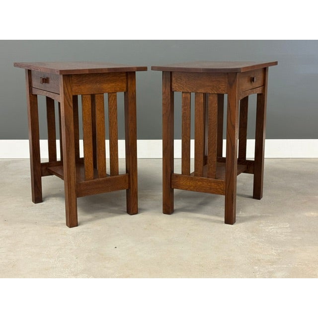 A pair of arts and crafts mission style nightstands constructed of solid oak. Dovetail drawers. Unmarked. Circa 1990’s....