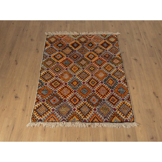 Wonderful vintage Berber rug with long fringes from the 1960s. Wonderful pile with patterns in cream, orange, red and blue...