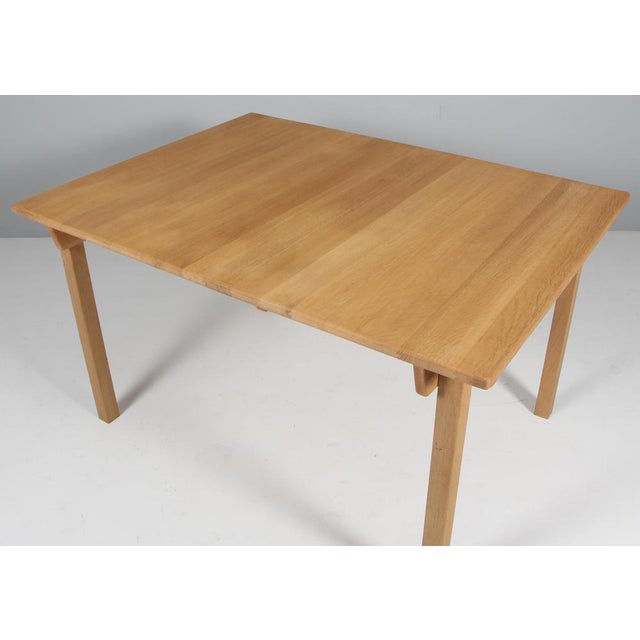 Hans J. Wegner dining table made of solid oak. Extension leaf. Made by GETAMA. This piece is attributed to the mentioned...