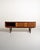 Scandinavian-made teak sideboard from the 1960s, featuring two sliding doors and three central drawers. The front features...