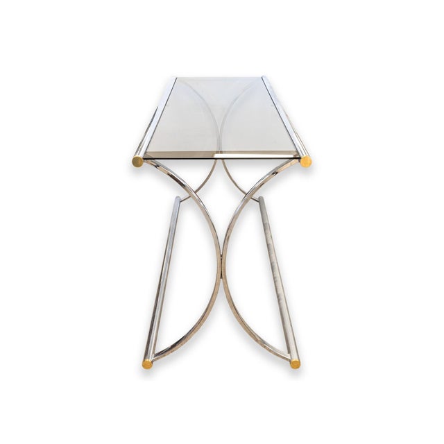 A Maison Jansen style console table. This beautiful accent piece features a chrome and glass construction. The chrome...