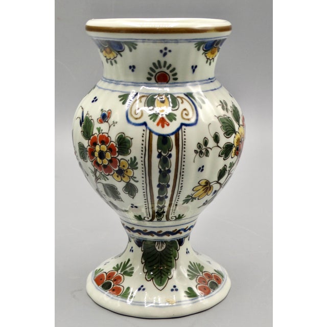 Royal Delft polychrome vase with a lovely pinched waist and foot. It is hand painted Dutch Delft and has the maker's mark...