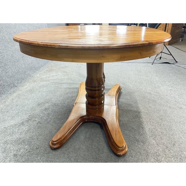 A beautiful vintage walnut dining table dating to approximately the 1960s-1970s, featuring a warm natural walnut finish,...