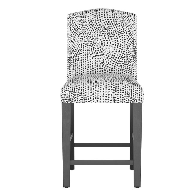 Dip just a toe outside of tradition with this uniquely shaped counter height dining chair, hand upholstered in a rich...