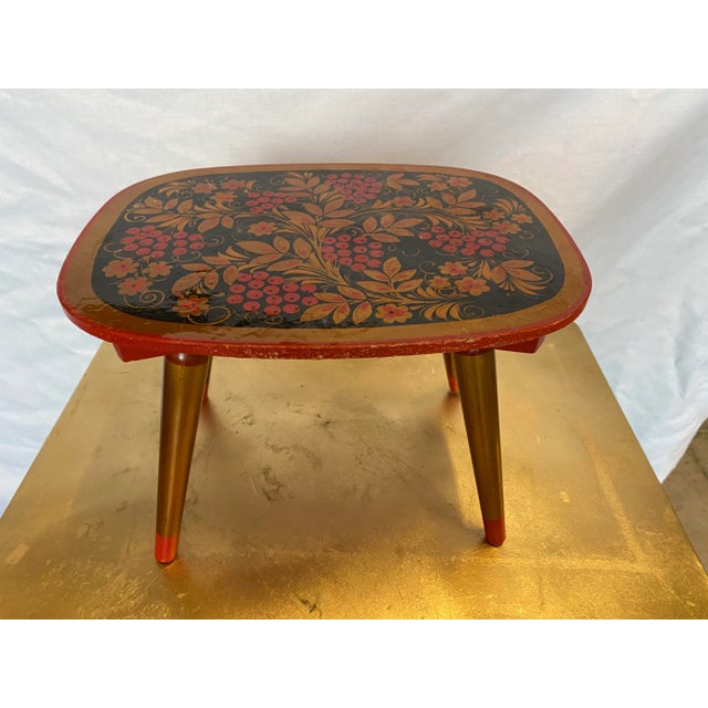 Stunning petite red and black stool is hand painted and a work of art itself. Perfect to add a pop of color into your...