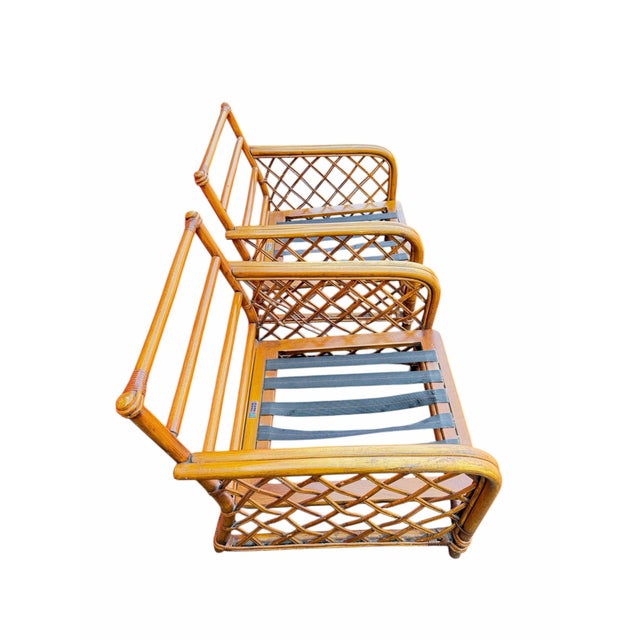 A stylish pair of vintage Ficks Reed rattan lounge chair frames featuring classic lattice side panels, wrapped joints, and...