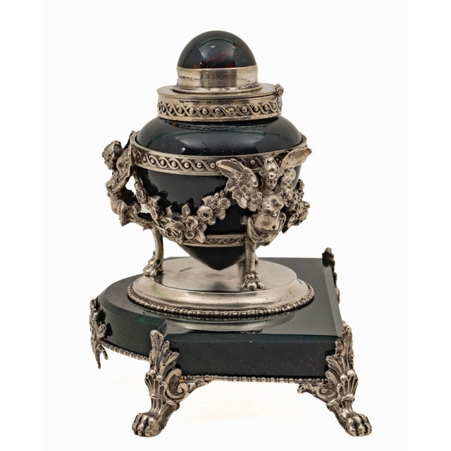 An exceptional French bloodstone and sterling silver mounted inkwell, dating to circa 1920, distinguished by its elaborate...