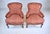 A lovely, solid pair of carved Walnut Bergere chairs in whimsical raised trunk elephants upholstery. Nicely maintained all...