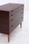 A beautiful vintage rosewood chest of drawers from the 1960s with a clean, compact form and striking, dark grain. The...