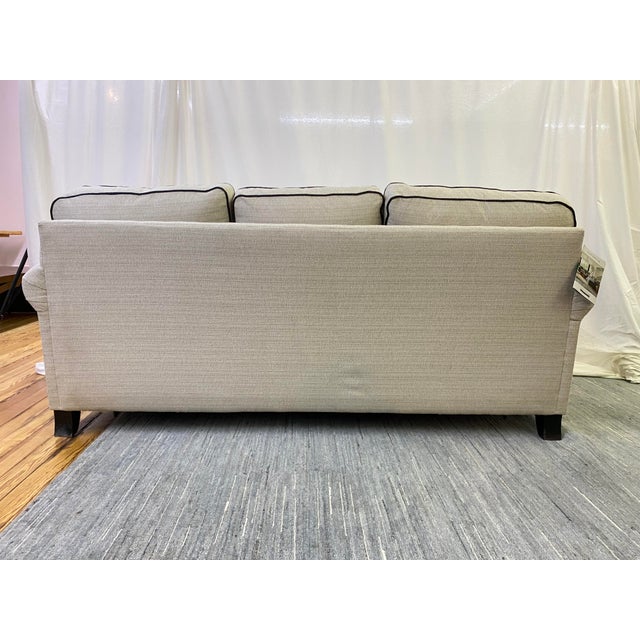 Craftmaster upholstered sleeper sofa featuring a clean transitional silhouette with rolled arms, plush loose cushions, and...