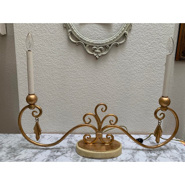 Glamorous swirled large gold decor lamp with chandelier bulbs and decorative accents. Plugs in and has three settings for...